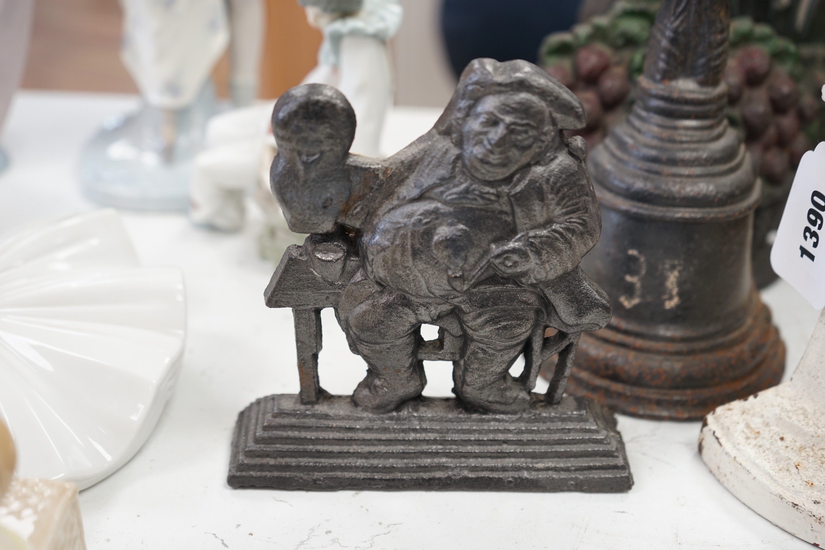 Six assorted Victorian cast iron door stops, some later painted, 27cm tall